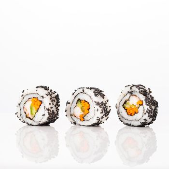 front view maki sushi rolls with sesame seeds. High resolution photo