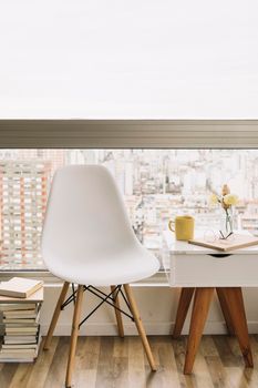 books near chair table. High resolution photo