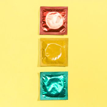 top view red yellow green condoms. High resolution photo