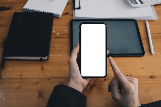 A Man hand holding smartphone device with blank screen. Blank screen for your advertising