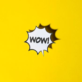comic cartoon speech bubble wow emotions yellow backdrop. High resolution photo