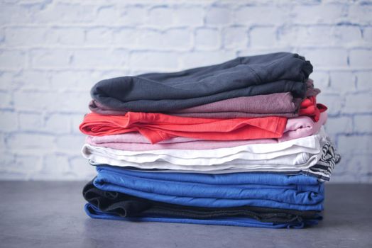 close up of stack of clothes on table