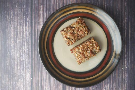 date fruit chocolate bar in a plate on table .