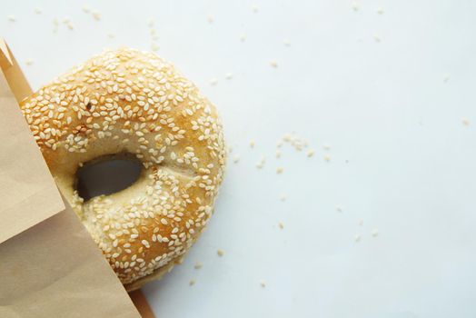 bagel and paper packet on white background .