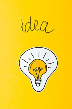 light bulb idea concept yellow background. High resolution photo