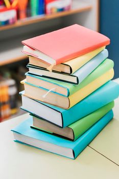 stack multicolored books table. High resolution photo