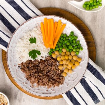 different types porridge with vegetables big wooden board. High resolution photo