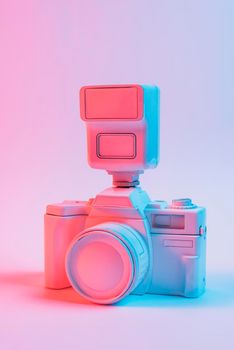 vintage pink painted camera lens against pink backdrop. High resolution photo