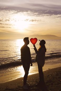 couple heart balloon sea shore evening. High resolution photo