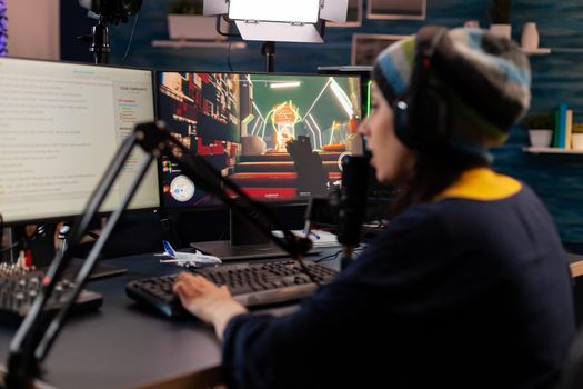 Pro streamer use headphones and looking into powerful monitor with gaming chat open. Online streaming cyber performing virtual tournament using technology network wireless