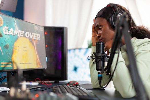 African esport streamer being upset losing video game championship. Professional gamer streaming online video games with new graphics on powerful computer.