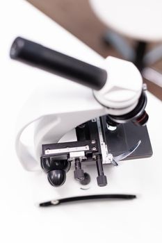 Medical microscope standing on table ready microbiology experiment in biochemistry pharmaceutical hospital laboratory. Chemical micro infection investigation. Biological expertise research