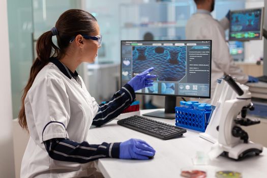 Chemical scientist conducting clinical virus research using computer. Scientists examining vaccine evolution in medical lab using high tech, chemistry tools for scientific research.