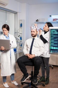 Women team neurological researchers working together developing treatment for diagnosis of brain disease, explaning eeg results, health status, brain functions, nervous system and tomography scan