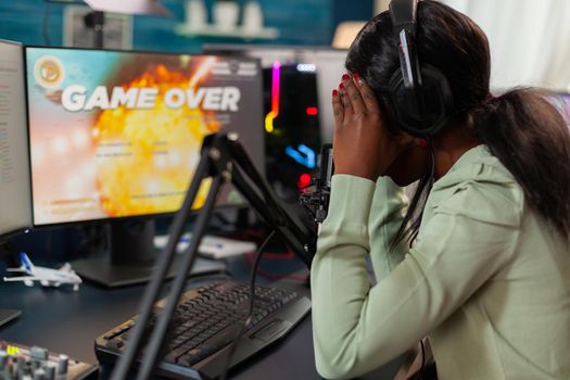 Disappointed african online game streamer losing championship, internet multiplayers. Professional gamer streaming online video games with new graphics on powerful computer.