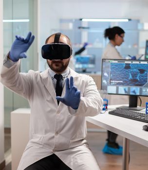 Professional scientist using medical inovation in lab wearing virtual reality glasses. Team of researchers working with equipment device, future, medicine, healthcare, professional, vision, simulator.