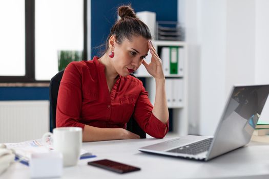 Angry frustrated upset businesswoman having problem with project and failure. Upset entrepreneur working on laptop in corporate workplace. Nervous manager while working on financial analysis.