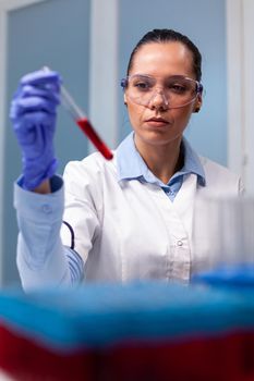 Specialist chemist analyzing blood test tube working at biochemistry experiment in medical researcher researcher. Scientist doctor discovering virus expertise researching disease infection