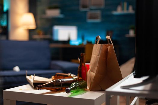 Garbage covered house apartment of alone woman with mental depresion having trash, rubbish with no people in. Unorganized empty living room of depressed person with scattered food mess, disorder table