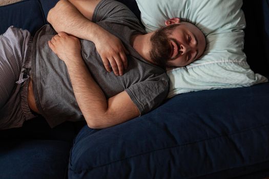 Vulnerable, scared, depressed, traumatized adult man finding news that makes to fall into mental suicidal state, crying and feeling unhappy, lonely , desperate suffering from physical disorder