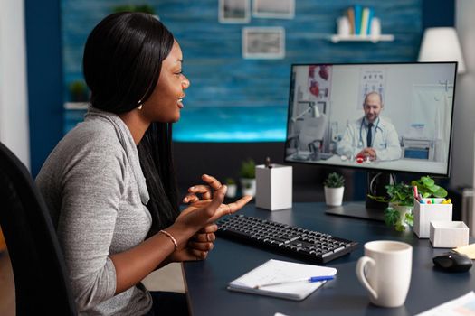 African patient talking with therapist doctor explaining disease test results discussing pills treatment during online telemedicine videocall conference meeting. Student having respiratory illness