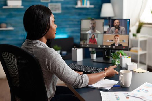 Black student discussing with university team during online videocall meeting conference teleconference explaining marketing ideas course. Computer user african woman working remote from home