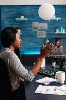 African american student waving remote school collegue during online videocall meeting teleconference discussing marketing course ideas. Black woman using university elearning platform