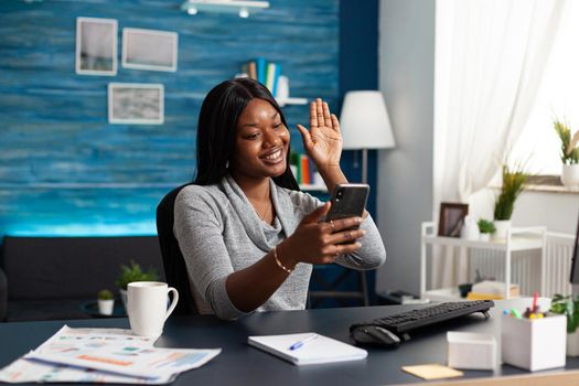 African american student chatting with remote friends discussing university math course during online videocall meeting conference. Black woman working from home at education lesson