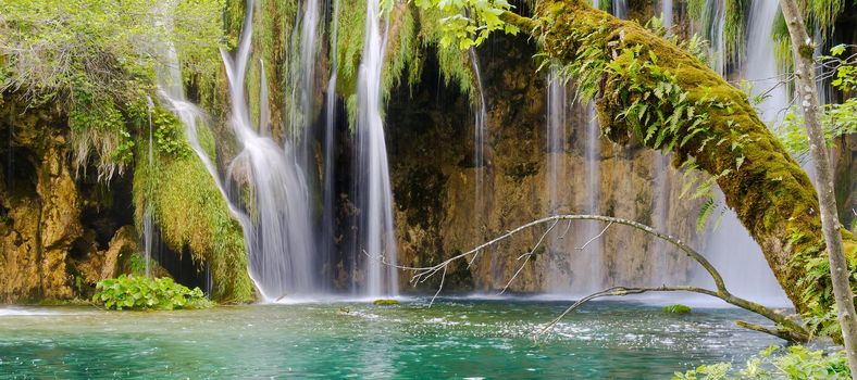 Waterfall in Plitvice Lakes national Park at summer, Croatia. Waterfalls formed by mountain lakes due to melting glaciers