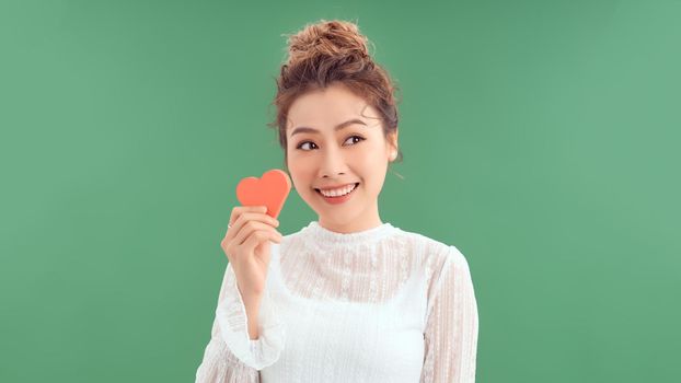 girl holding a paper heart