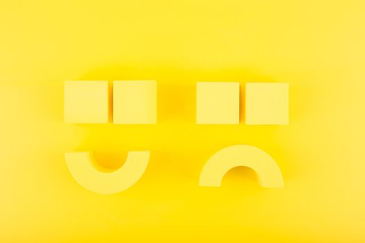 Creative flat lay with unhappy, sad and happy smiling smile symbols made of yellow figures on yellow background with. Concept of emotions, emoji, mental health or customer satisfaction evaluation