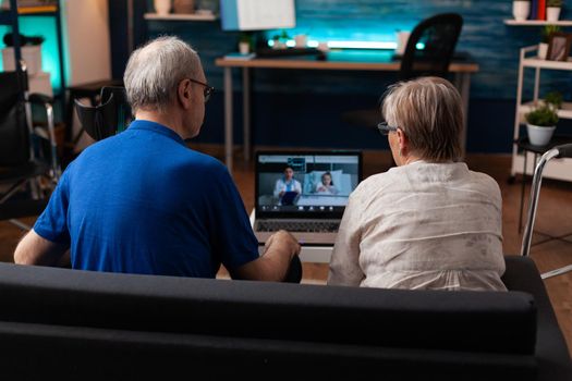 Grandparents worried for little girl in hospital ward using video call communication with doctor for healthcare checkup and healing treatment procedure. Old couple on telemedicine conference