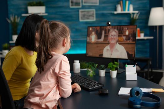 Parent and little kid meeting with grandma on video call virtual communication. Family of two using online modern conference for checking on relatives while social distancing at home