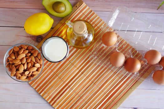 eggs in a plastic container, milk and almond nut in table ,