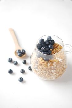 cereal breakfast and blue berry in bowl on table .