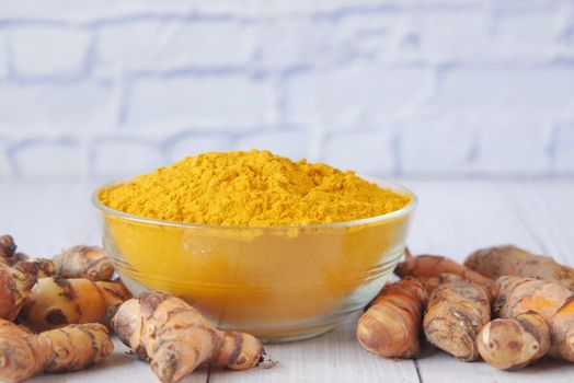 detail shot of turmeric root in bowl on table