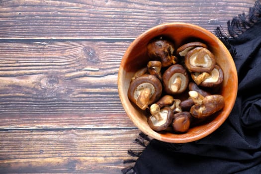 raw champignon mushroom in a bowl on table .