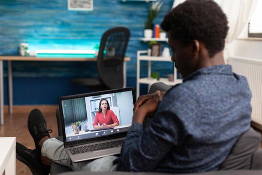 Black remote person working from home on video call talking on online internet conference with woman coworker. African american man on website teleconference, using computer device