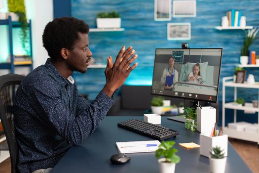 Worried black family man about child in hospital ward talking with doctor on video conference call using webcam for online connection. Telemedicine patient learning about disease