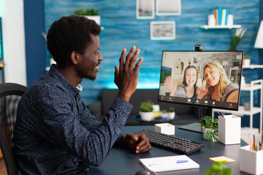 African american man talking on online video call with family and friends using webcam. Black man using digital internet conference from home office for virtual chat communication