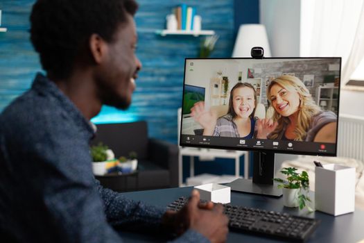 Black man talking with friends and family on video call using webcam and communication. African american person chatting on online conference from home office for social distancing