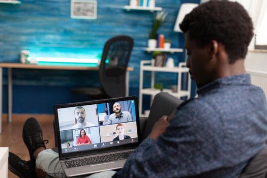 African american ethnicity man using conference webcam communication to connect via internet with coworkers while working from home. Black man remote worker chatting on business video call