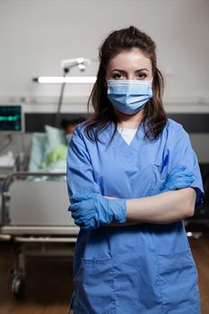 Portrait of woman working as nurse at clinic in hospital ward looking at camera with uniform and protection face mask. Caucasian specialist adult with medical occupation for healthcare