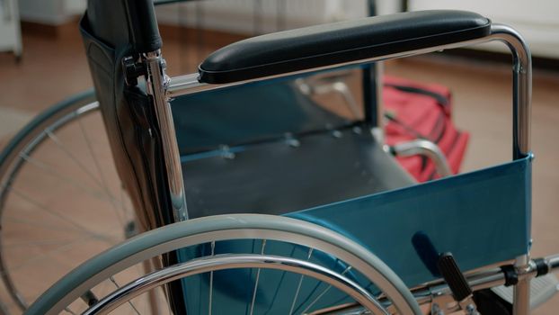 Close up of wheelchair for transportation assistance and support. Chair for physical recovery and rehabilitation used by disabled or injured patients in nursing home. Medical care