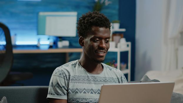 Close up of freelancer using laptop for remote communication with colleagues about business work. Person looking at device and browsing internet for networking project at home.