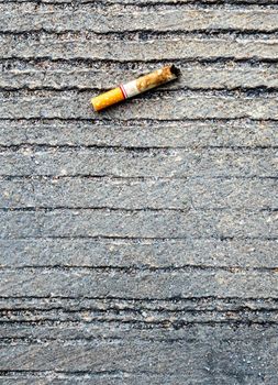 The cigarette butt let down on the concrete floor