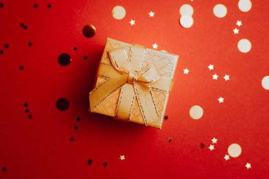 Yellow New Year gift . New Year and Christmas. Copy space. An article about choosing a gift. Red background
