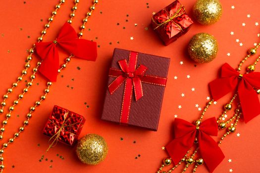 Red Christmas gifts and Christmas trees on a red background. An article about the New year and Christmas. The choice of gifts. A red gift . New Year's background