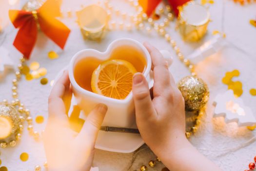 New Year's tea with hands on a white background . Glitter and white background. Holiday. Holiday decorations. The layout is a festive tea party. Christmas