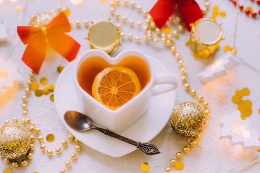 New Year 's tea on a white background . Glitter and white background. Holiday. Holiday decorations. Hot tea . The layout is a festive tea party. Christmas